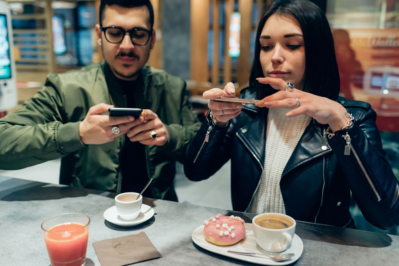 Couple photographing their food and drink