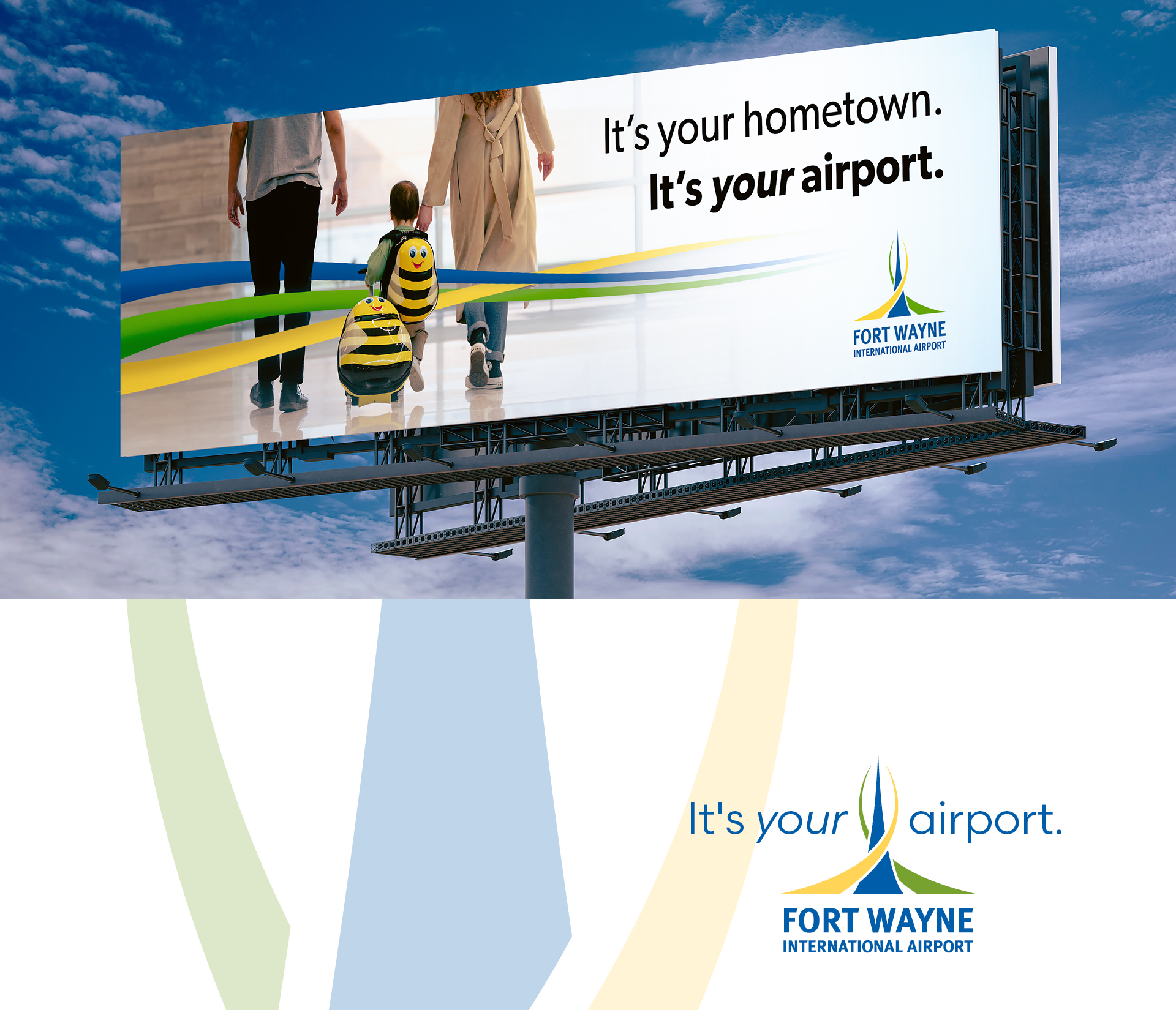 Outdoor billboard against a blue sky reads: 'It's your hometown. It's your airport.' with the Fort Wayne International Airport logo visible on the right side.