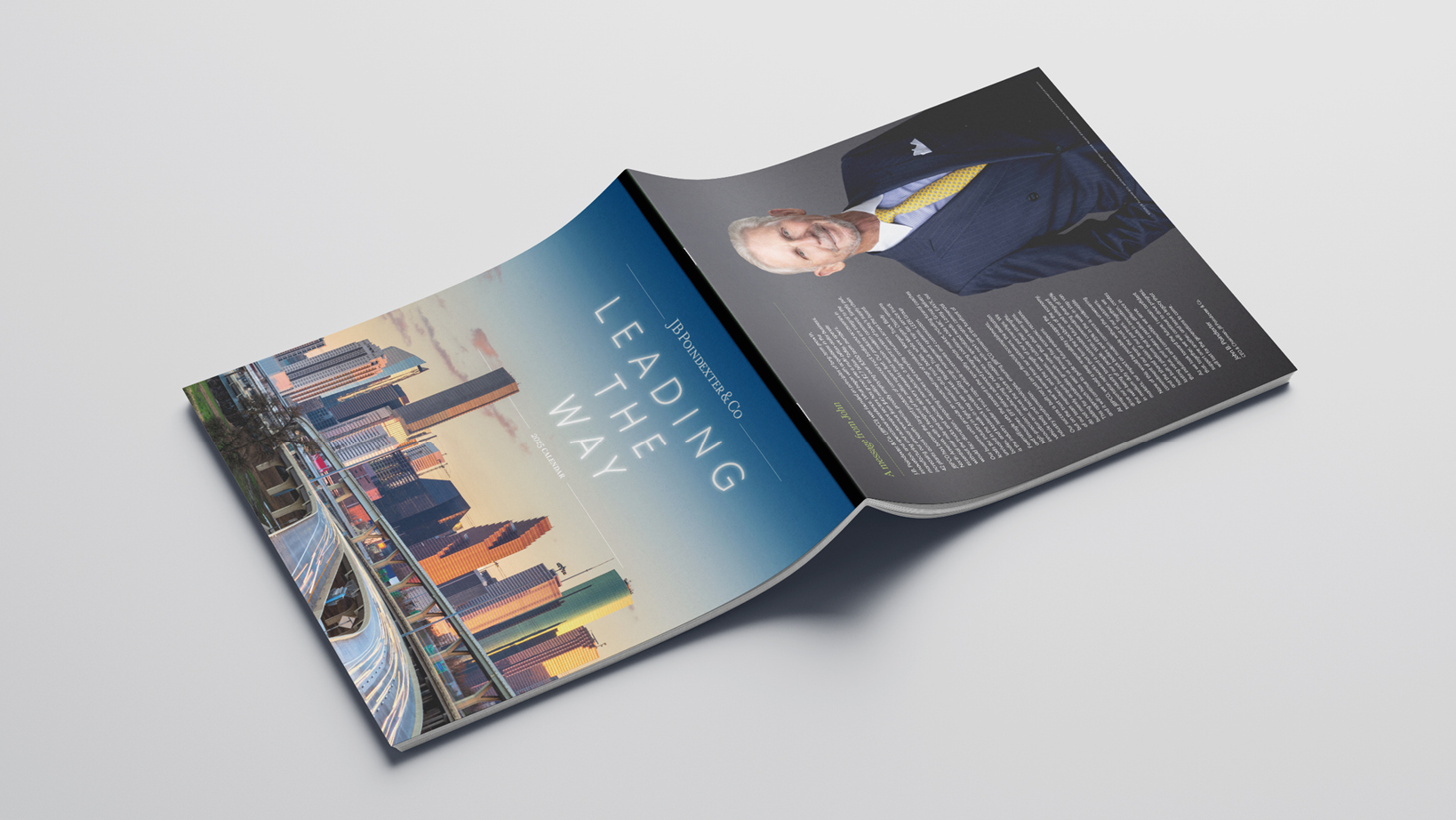 Open magazine spread: left page shows a city skyline photo with 'Leading the Way' title; right page features a suited man and dense article text.