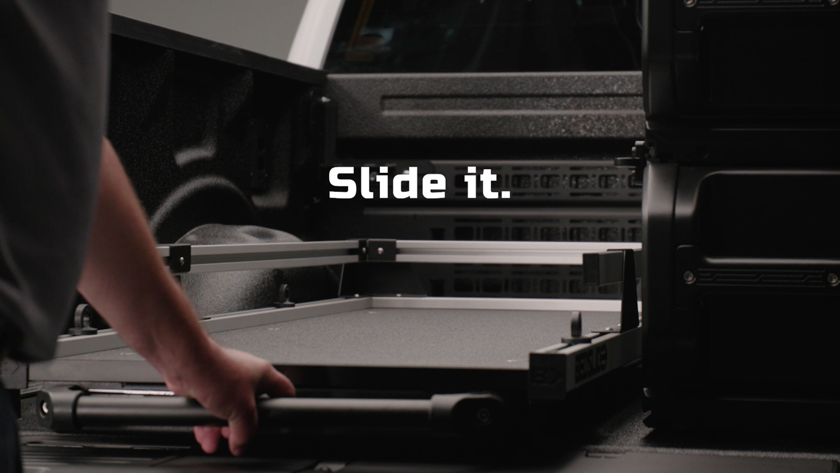 Person’s hand slides out a metal tray from a rugged equipment case, with the caption 'Slide it.' visible on the image