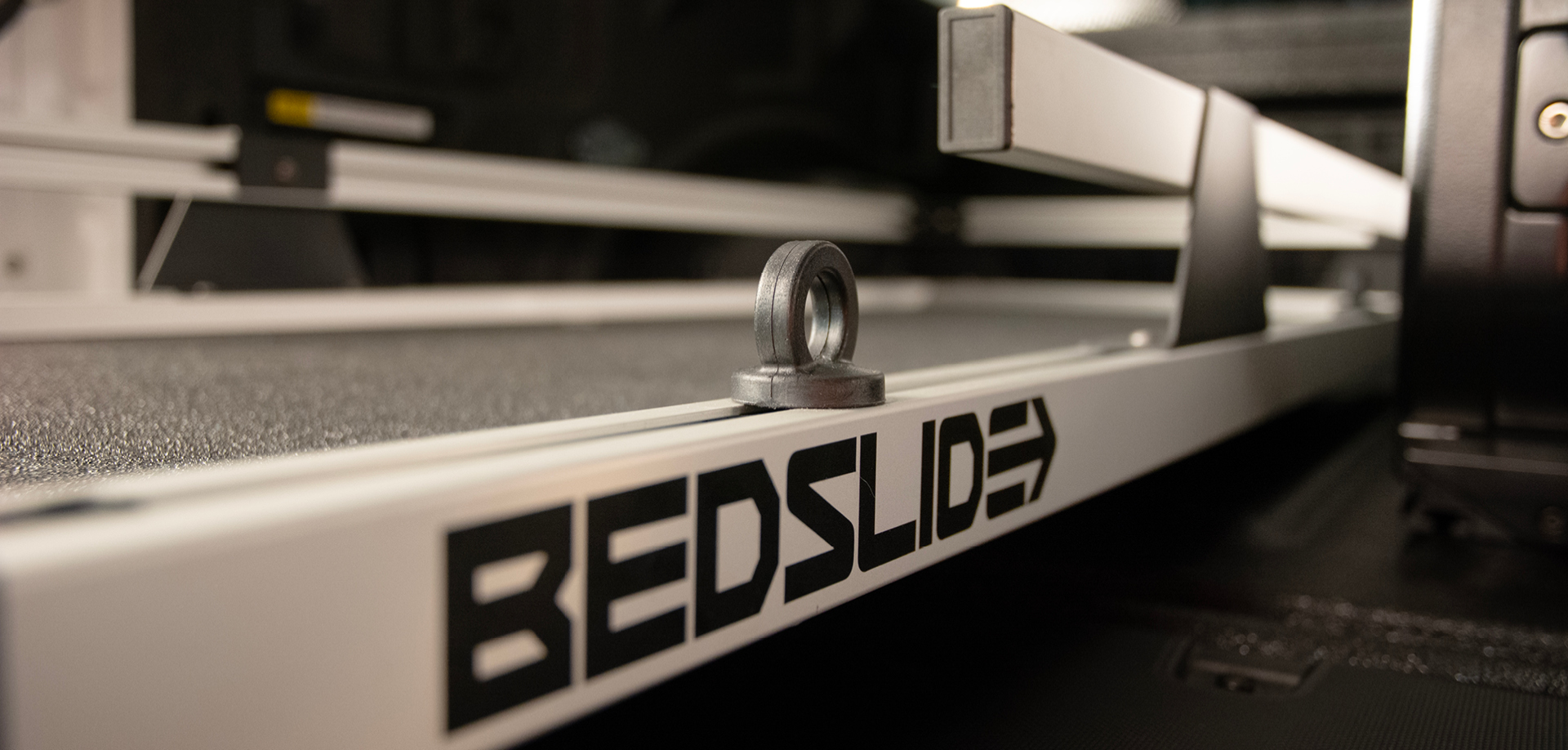 Close-up of a circular metal bearing resting on a linear rail of a 3D printer, with 'REDSLIDE' branding visible on the side.